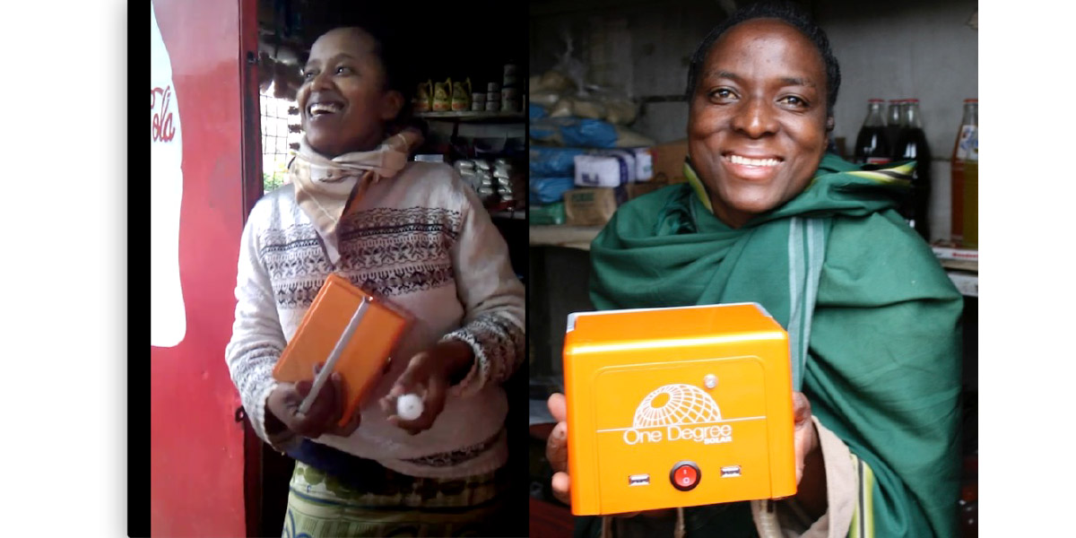 Two Kenyan kiosk owners holding BrightBox units inside their Coca-Cola branded shops
